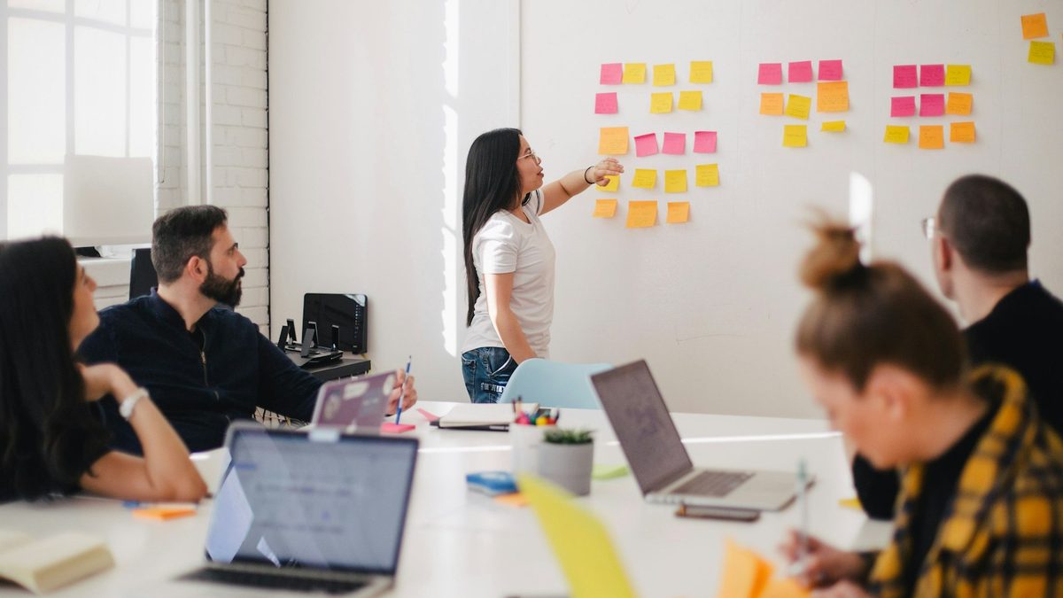 A marketing team reviewing performance numbers together in a meeting room